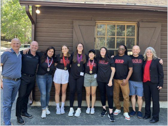 BOLD graduates and CI Web Group leaders in a group lineup outside the lodge