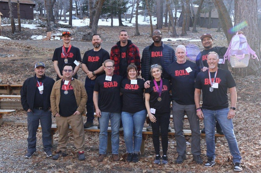 BOLD winter cohort in black BOLD shirts with medals