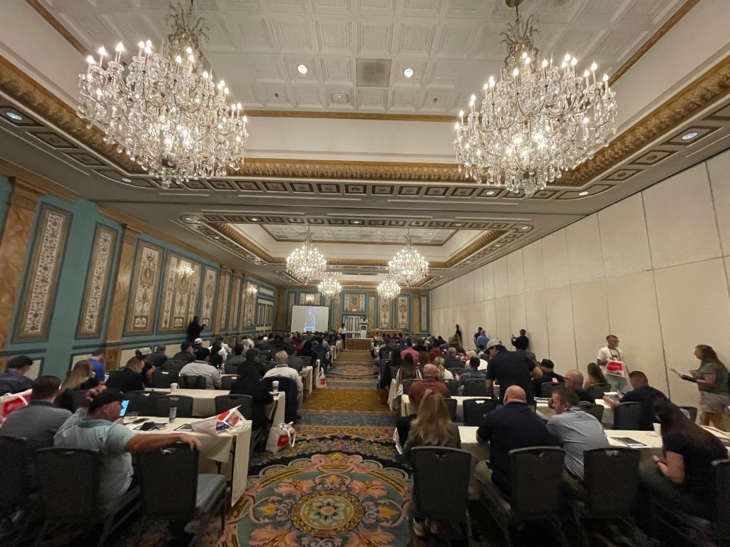 Industry audience in a grand ballroom session