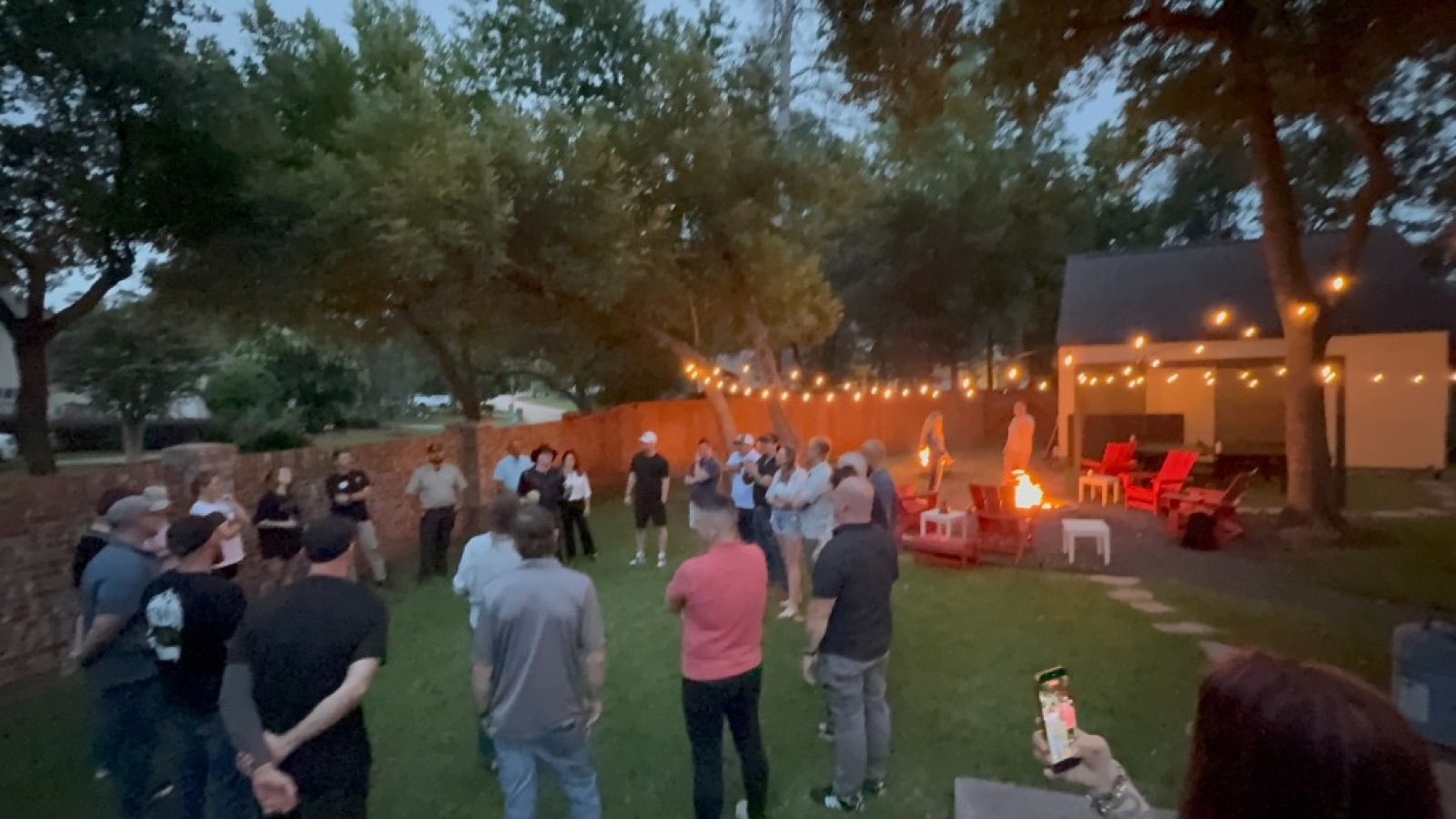 CI Web Group team and trades operators at an evening backyard community gathering