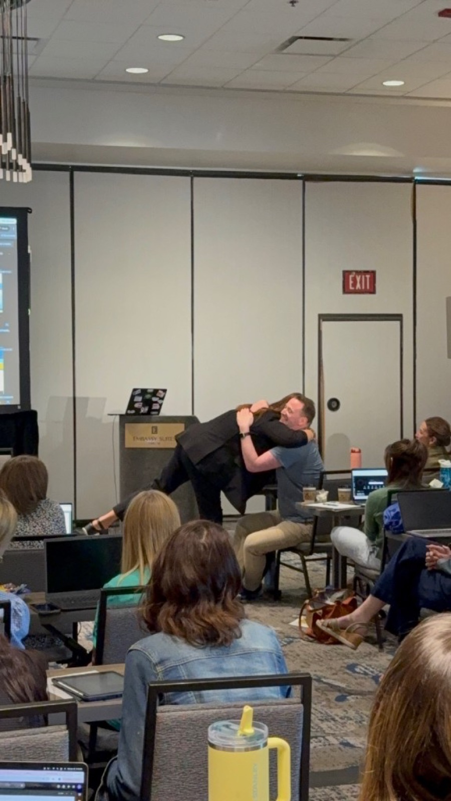 A heartfelt moment between Jennifer Bagley of CI Web Group and a contractor at an AI training workshop