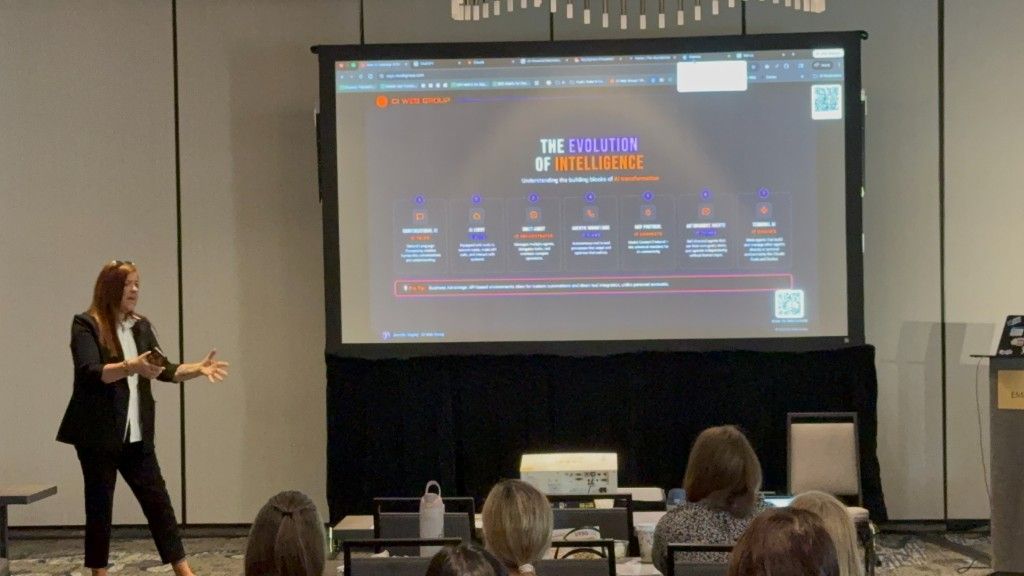 A CI Web Group presenter walking a full room through an AI workflow on a projector screen