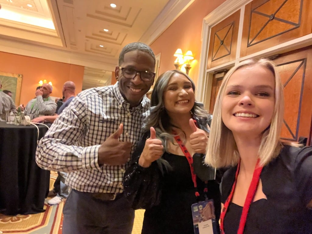 A CI Web Group team member with a guest at a ballroom reception