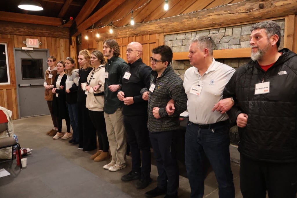 CI Web Group team members linking arms during a BOLD Advanced Leadership exercise
