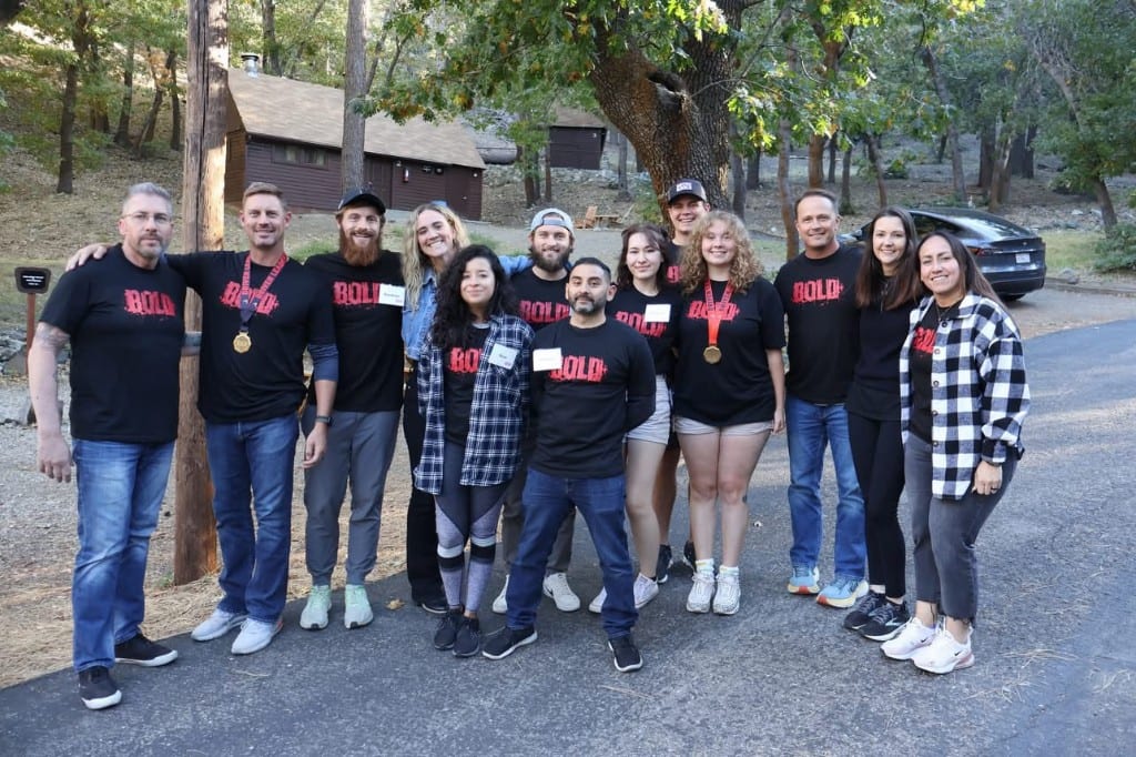 CI Web Group team in BOLD shirts with medals at a BOLD Advanced Leadership session