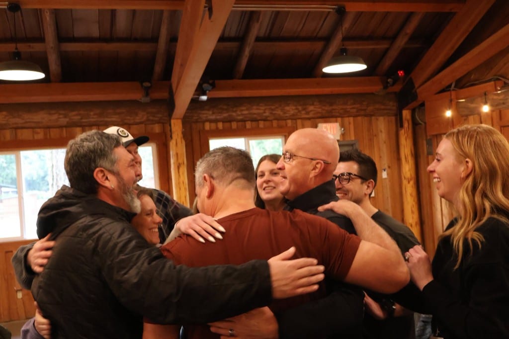 CI Web Group team members sharing a group embrace at the BOLD Advanced Leadership program