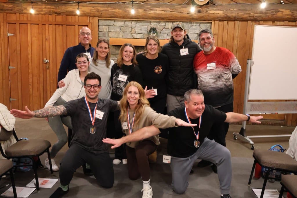 CI Web Group team members striking playful poses with their BOLD Advanced Leadership medals