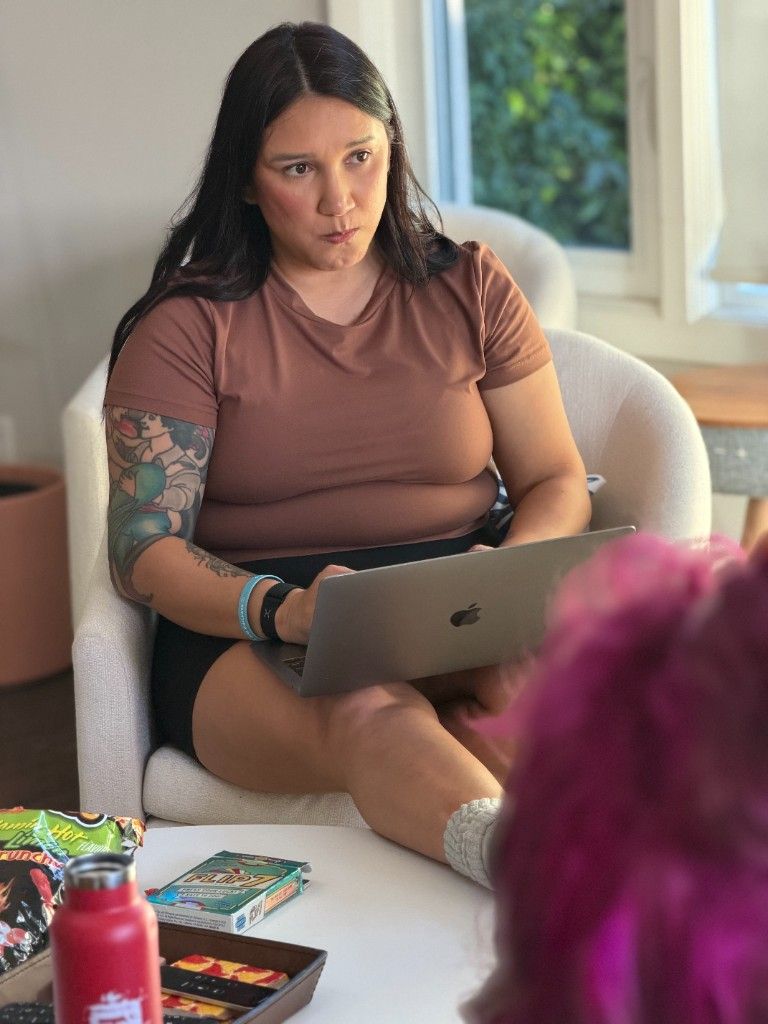 A CI Web Group team member working on a laptop in an armchair