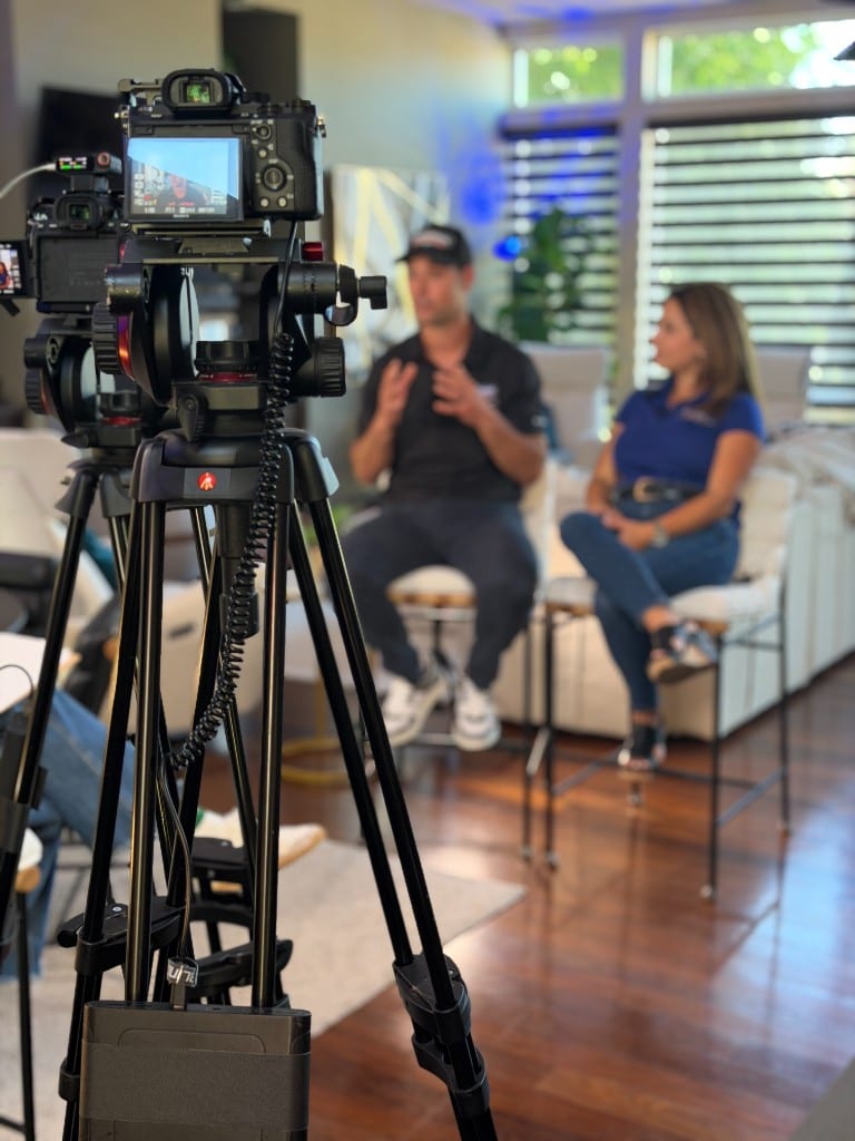 A CI Web Group client interview being filmed with a cinema camera on a tripod