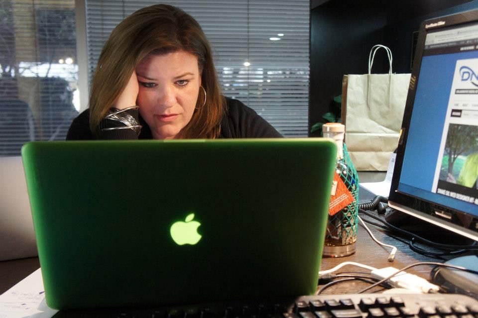 A CI Web Group team member focused at a laptop reviewing a client website