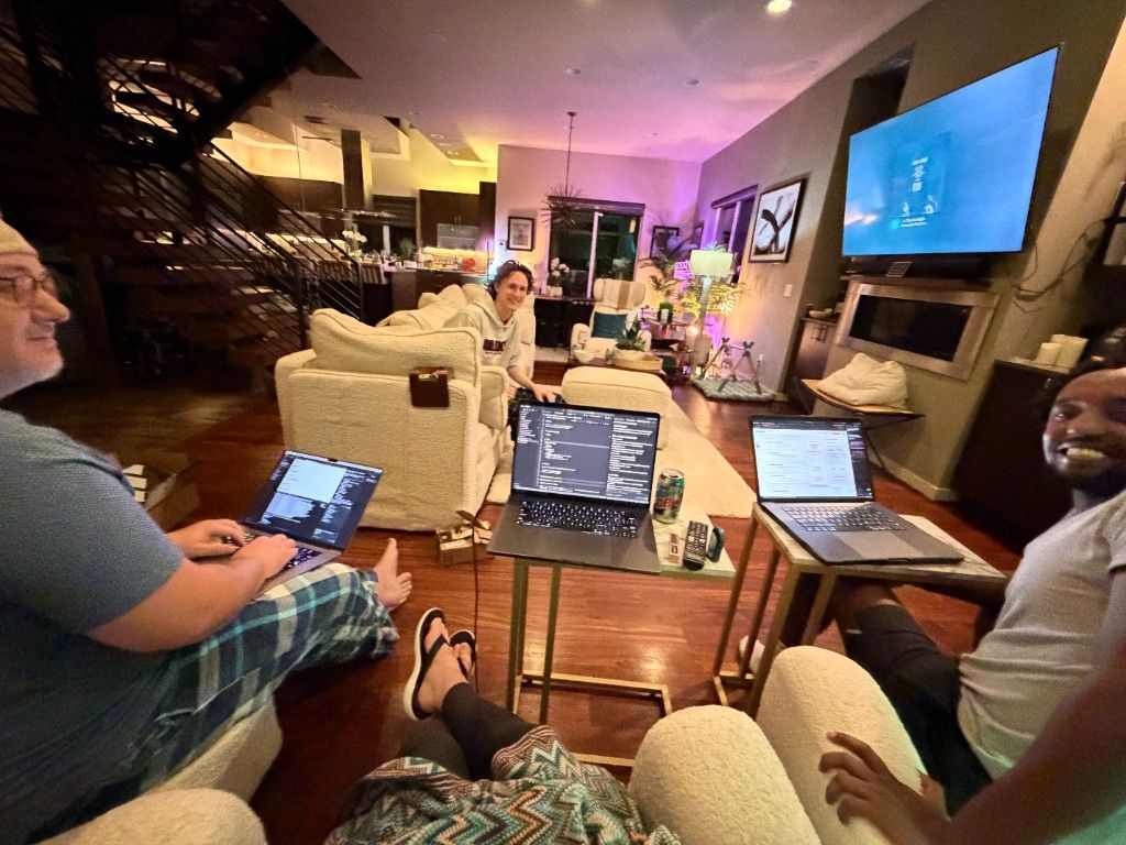 CI Web Group team members working late into the night on laptops in a living room