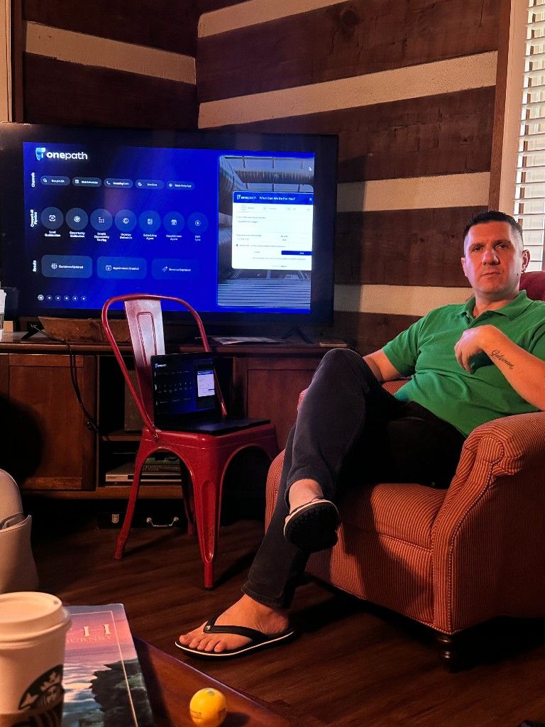 A team member reviewing a OnePath AI demo on a large screen from a living room