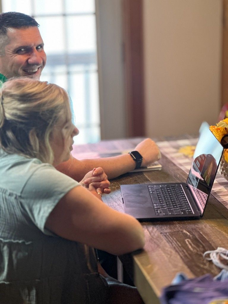 Two CI Web Group team members working together at a table