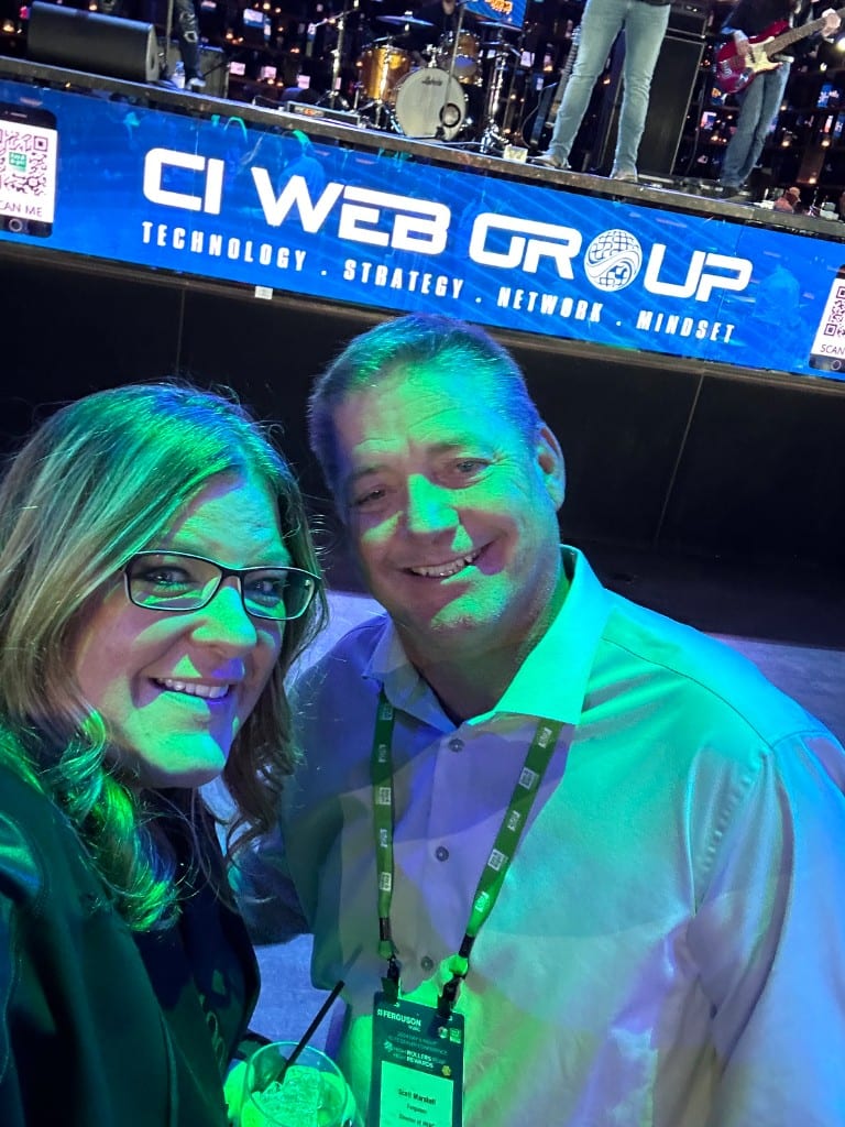 A CI Web Group team member and a guest at a live event under the CI Web Group banner