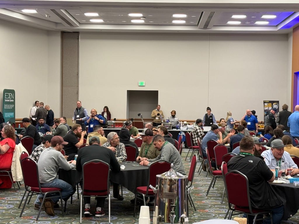 Contractors seated at tables for a session at a distributor dealer event
