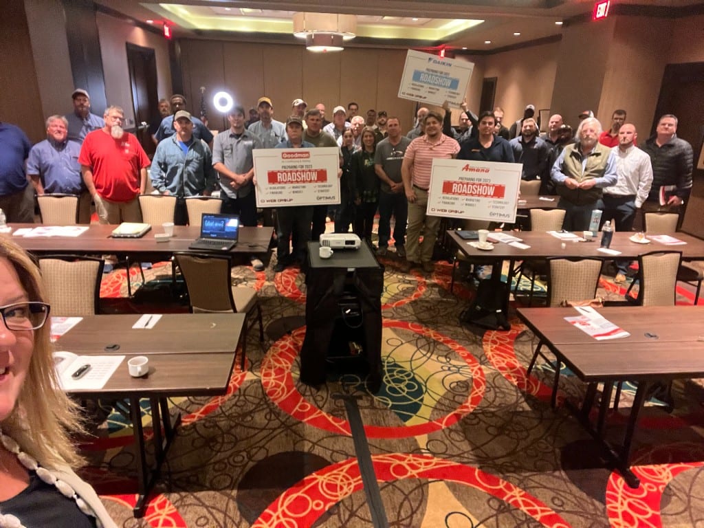 A full ballroom of contractors at an evening distributor dealer meeting
