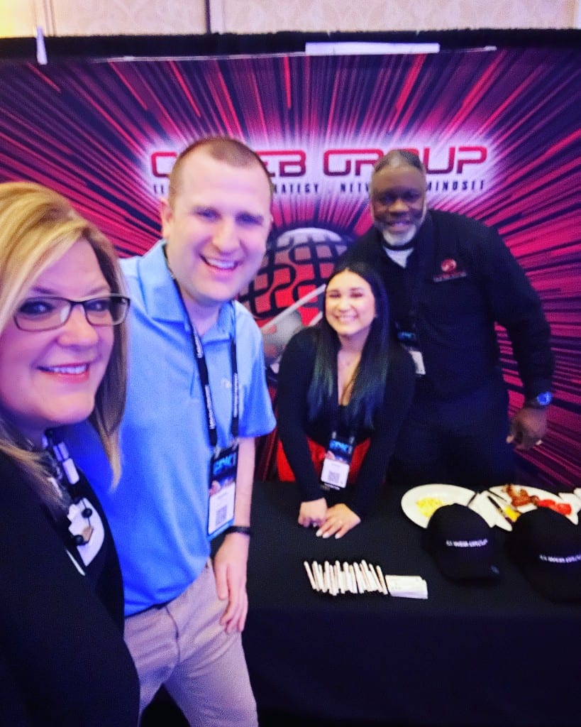 CI Web Group team and a client at the EPIC conference booth