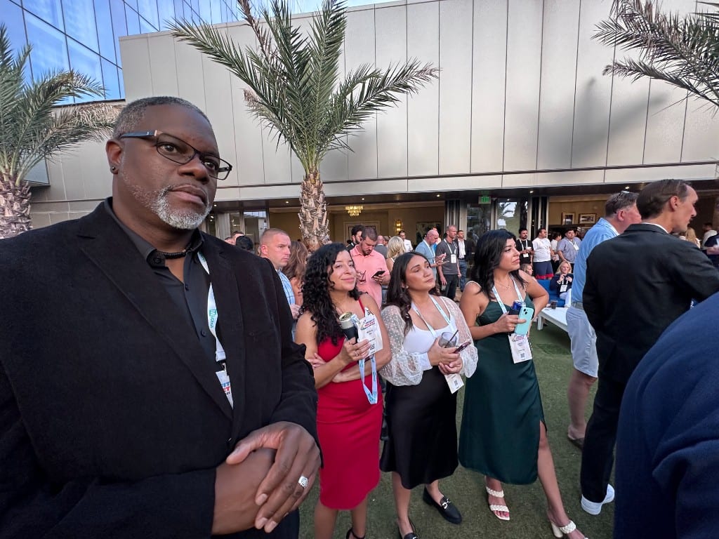 A CI Web Group team member at an outdoor evening industry reception
