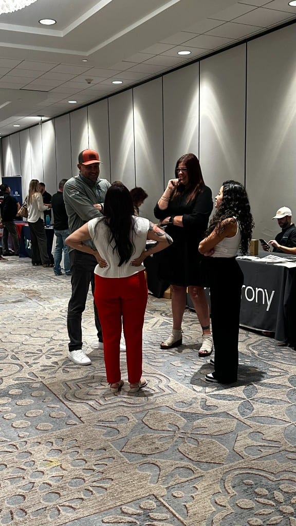 Trades professionals in conversation on an industry expo floor