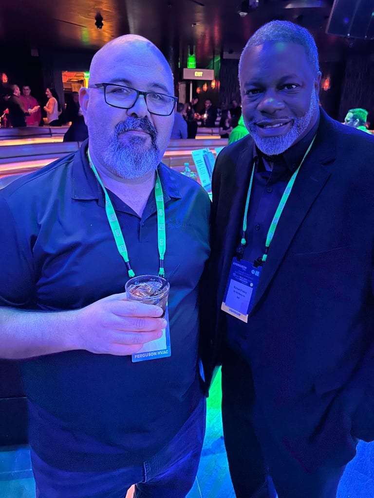 A CI Web Group team member with a Ferguson HVAC partner at an evening reception
