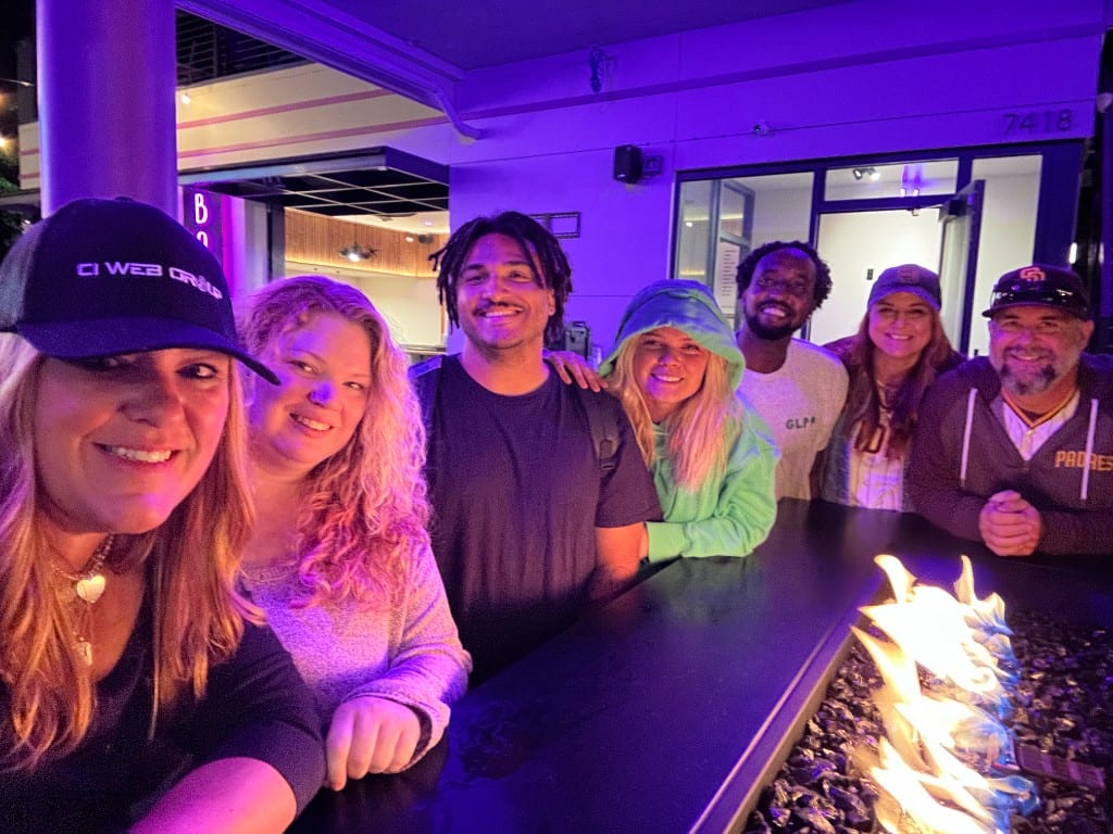 The CI Web Group team gathered around a fire pit in the evening
