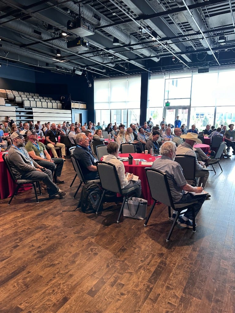 Industry professionals seated for a session at a heat pump summit