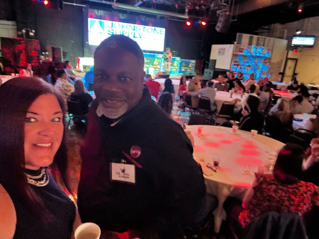A CI Web Group team member with a partner at a Johnstone Supply event