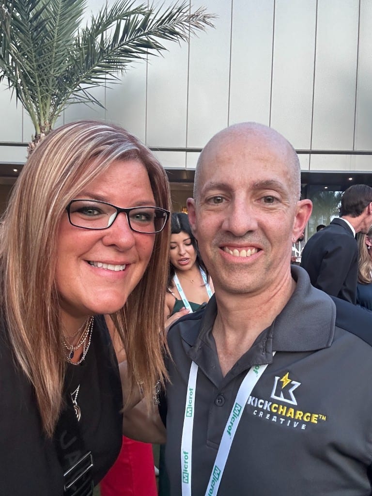 CI Web Group with a KickCharge Creative partner at an industry event