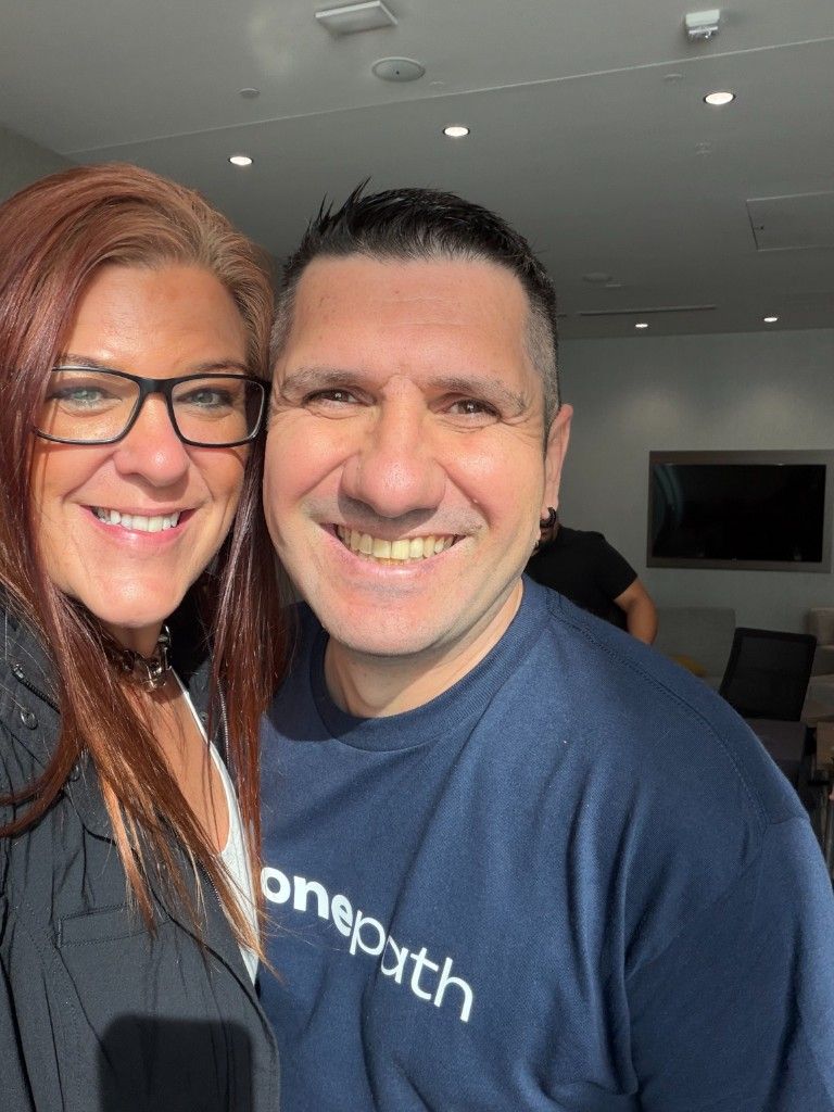 A CI Web Group team member with a OnePath partner