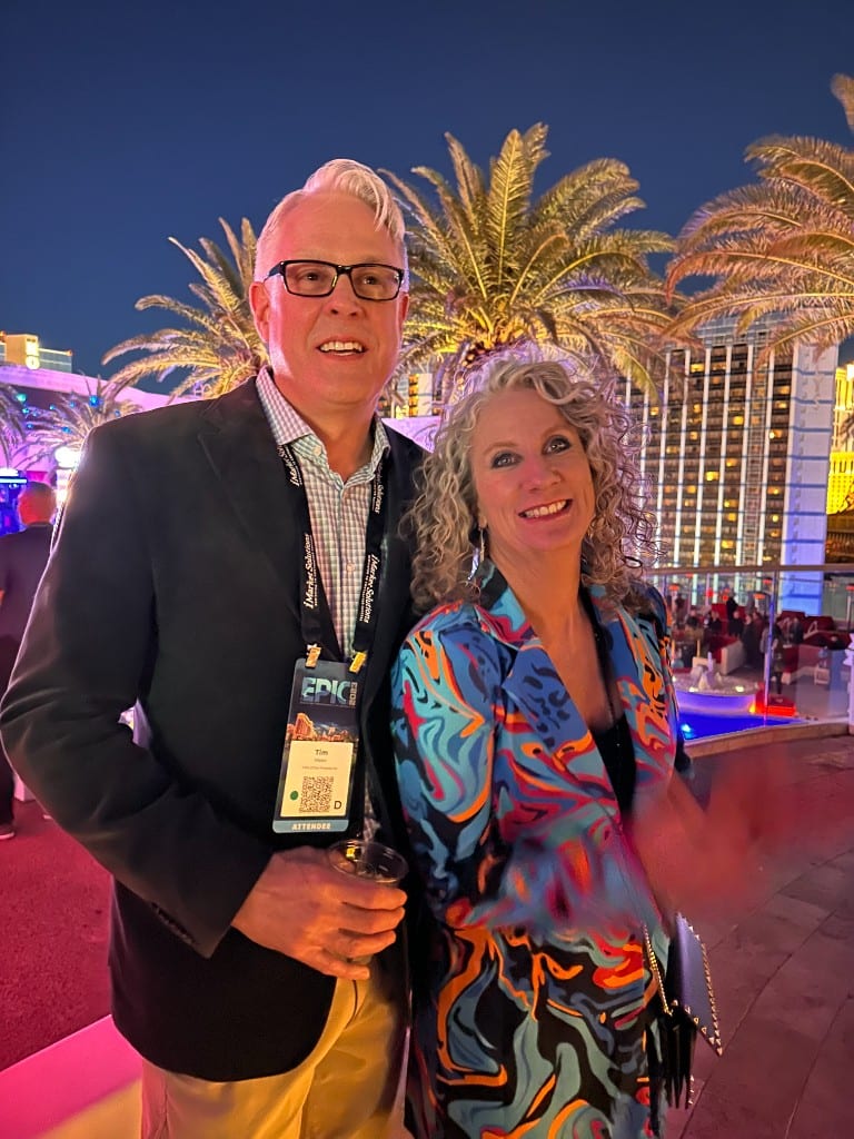 A CI Web Group team member with a guest at an evening reception on the Las Vegas Strip