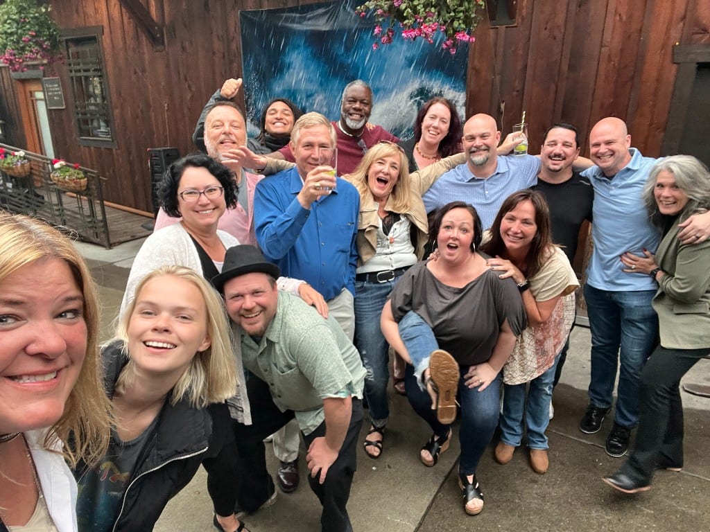 The full CI Web Group team laughing together at a celebration