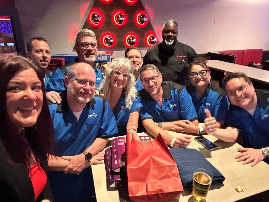 CI Web Group team celebrating at a dinner with thumbs up