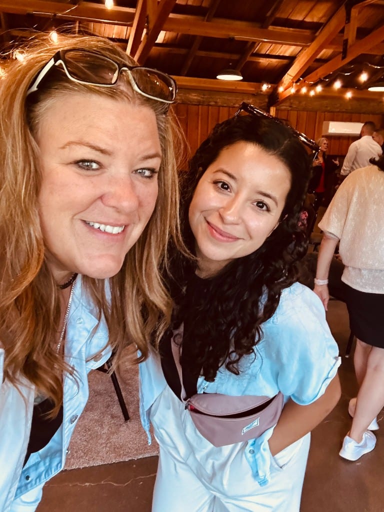Two CI Web Group team members taking a selfie at an evening event