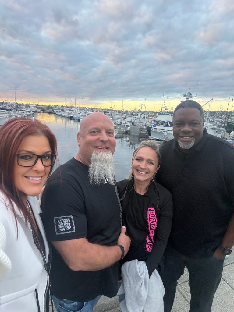 CI Web Group team members at a marina at golden hour