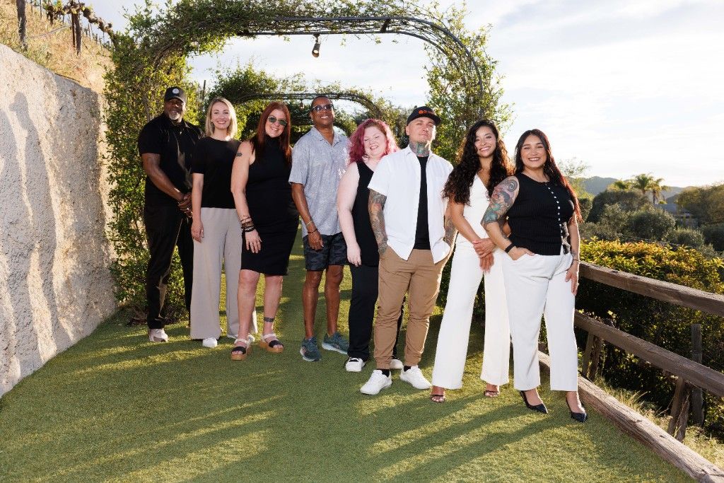 CI Web Group team gathered under a vineyard pergola