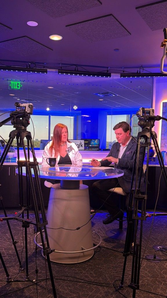 A CI Web Group interview being filmed on a television studio set
