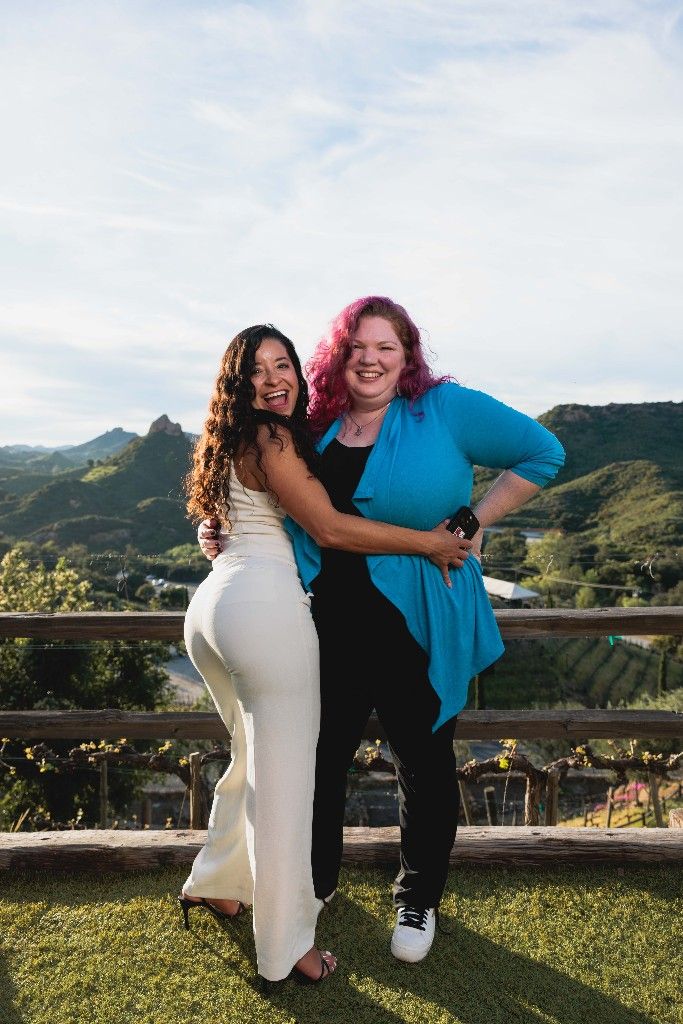 Two CI Web Group team members at a mountain overlook at dusk