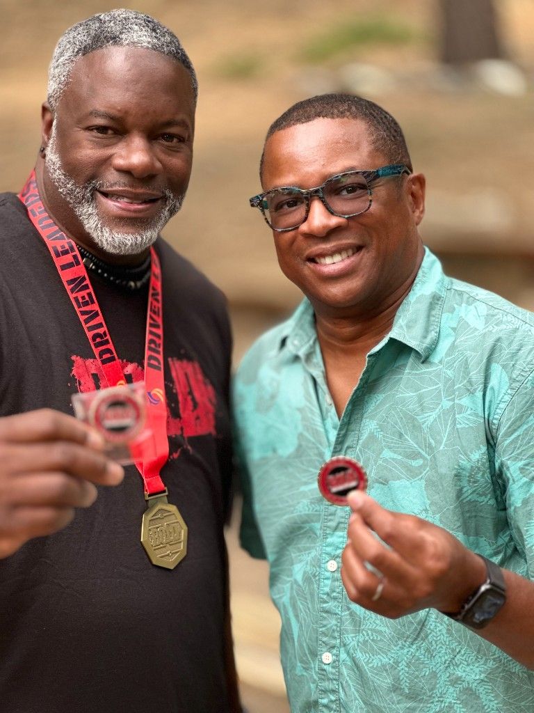 Two industry leaders holding Daikin dealer award medals at an event