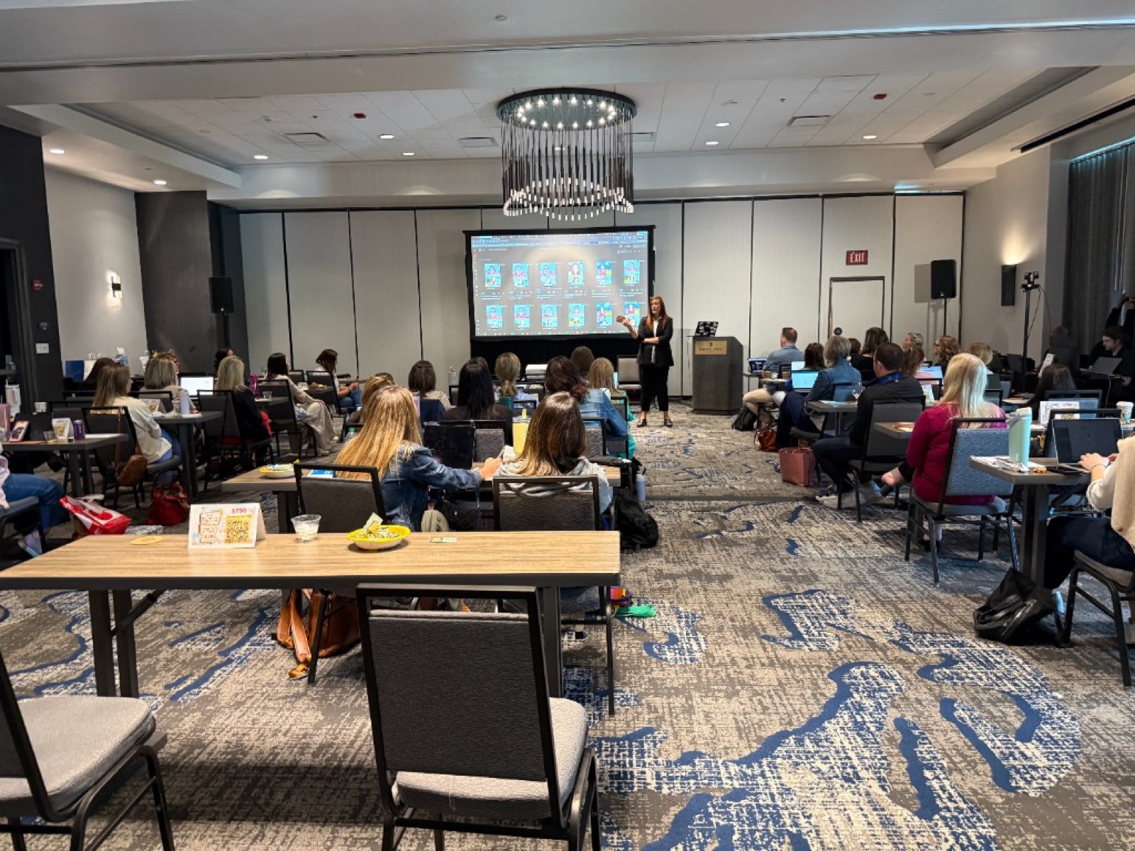 Jennifer Bagley of CI Web Group leading a hands-on AI training workshop for a full room of trades professionals