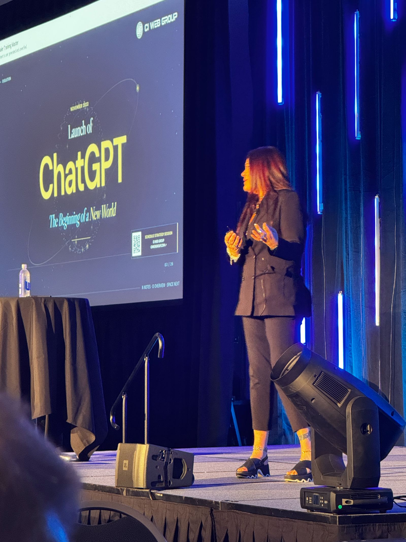 Jennifer Bagley gesturing while presenting on the history of ChatGPT