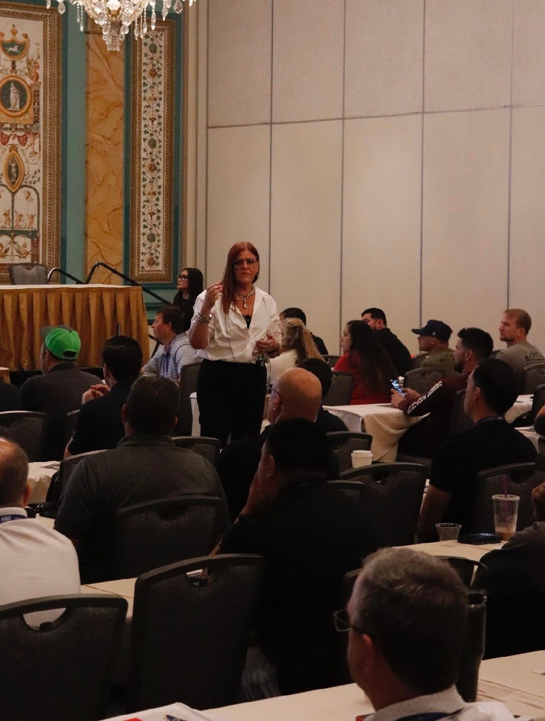 Jennifer Bagley speaking to an audience of trades business owners