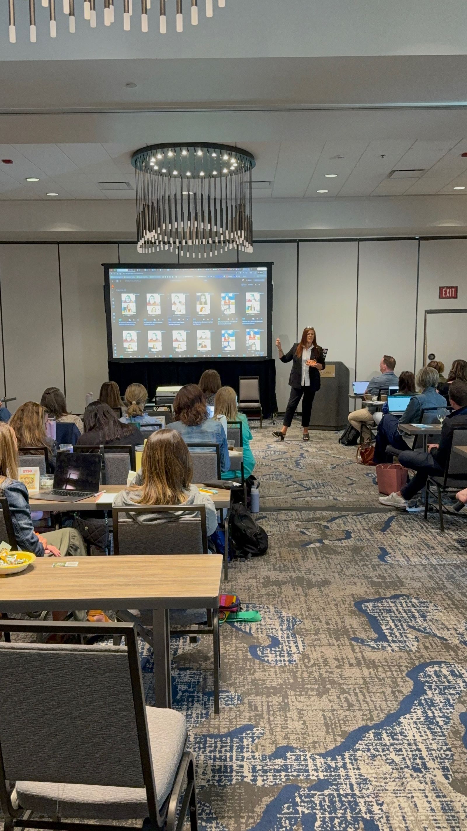 Jennifer Bagley leading a training session in a meeting room with attendees at tables