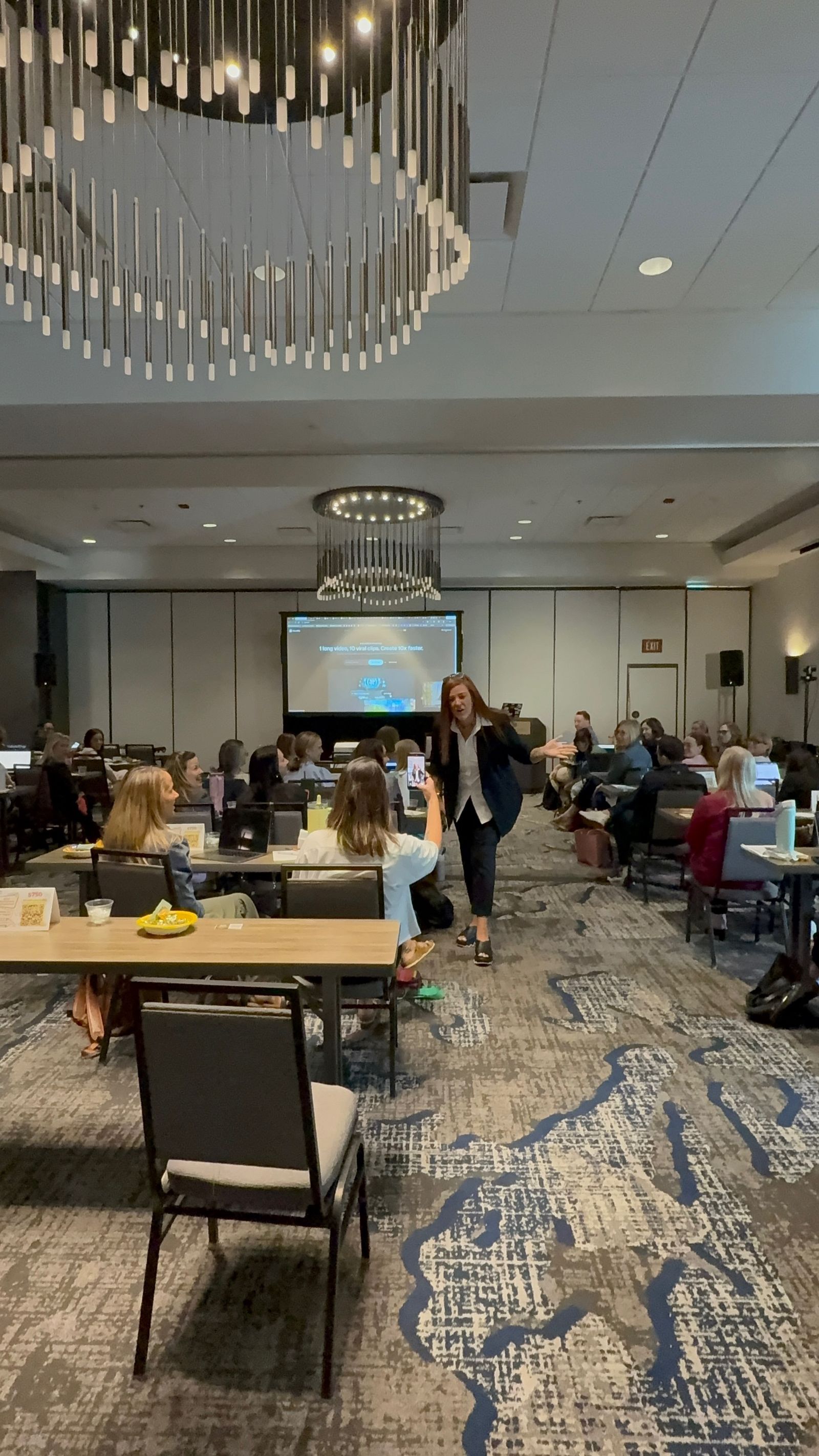 Jennifer Bagley walking through the room and engaging attendees during a workshop