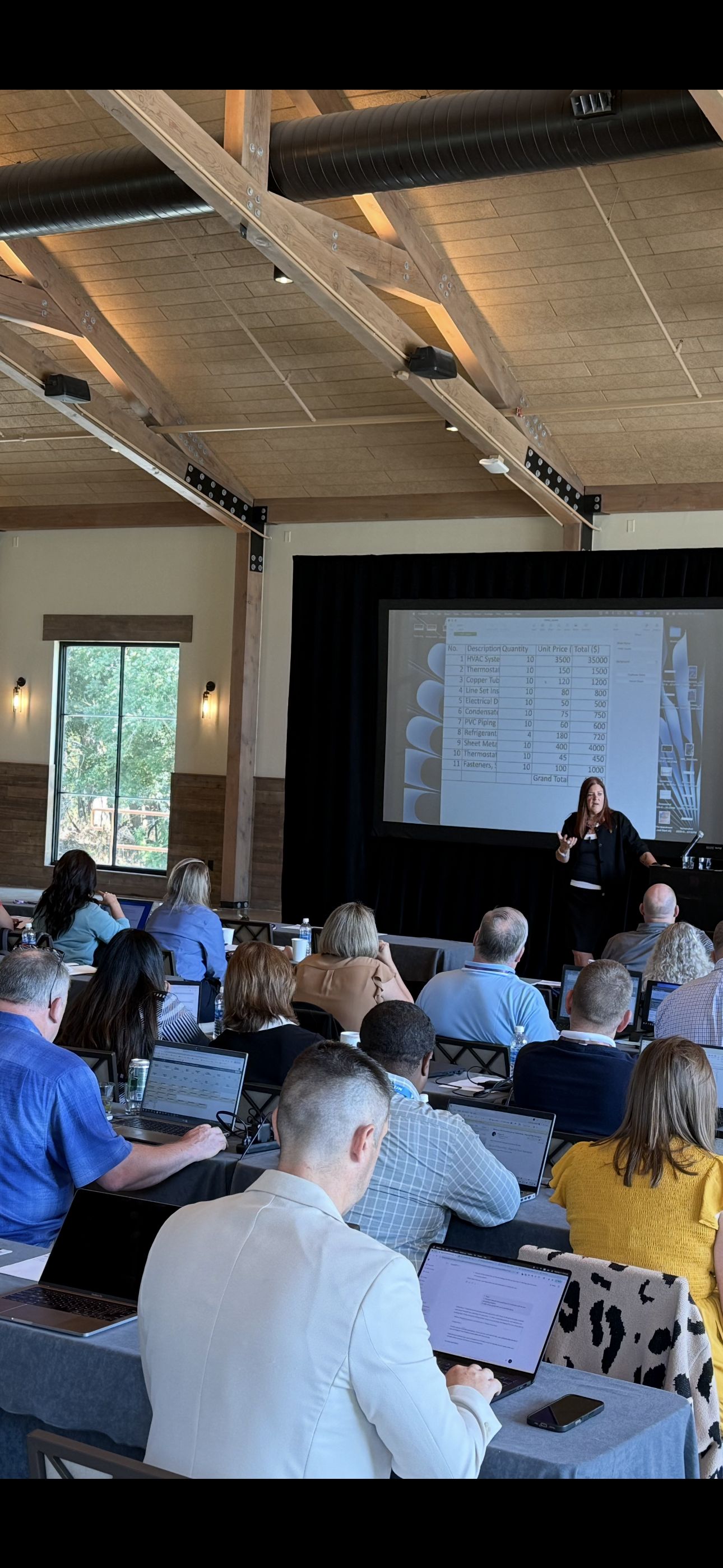 Jennifer Bagley leading a workshop session with attendees at their laptops