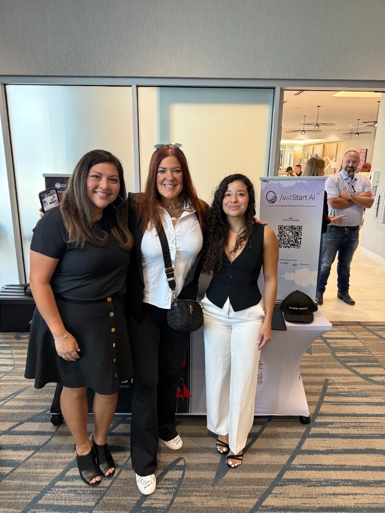JustStartAI community booth at an industry event