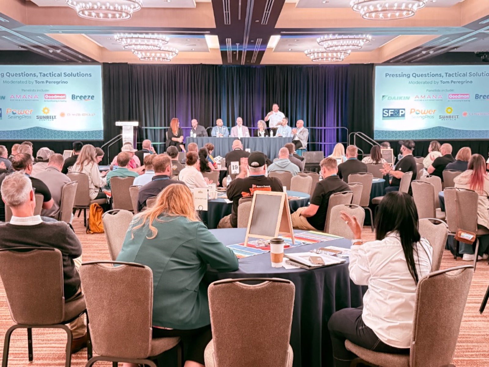 A full ballroom for the 'Pressing Questions, Tactical Solutions' panel featuring CI Web Group alongside Daikin, Amana, and Goodman