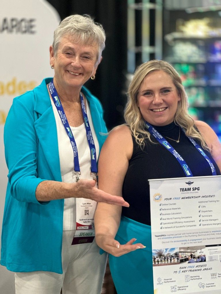 Two professionals with a Trade Ops award at an industry event