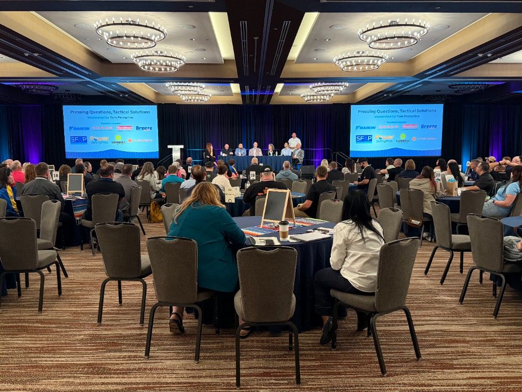 Wide view of a packed ballroom at a trades-industry conference