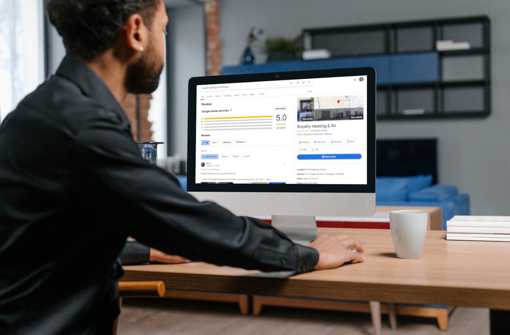 Man reviewing Google reviews on his computer at home.